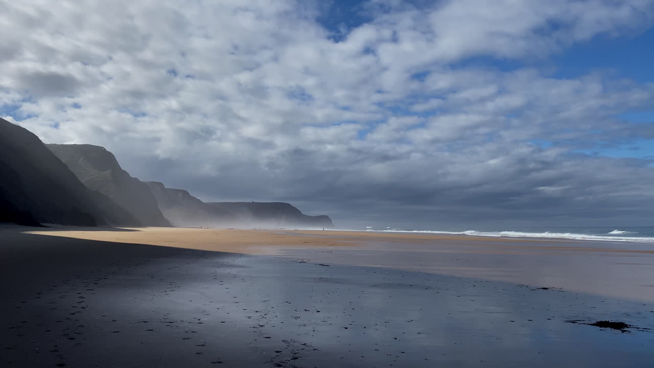 Pools of seawater shimmer across the rocky shore, capturing the blue sky and the pulse of the Atlantic Atlantic mist drifts between the cliffs of Sagres, softening the wildness of the coast