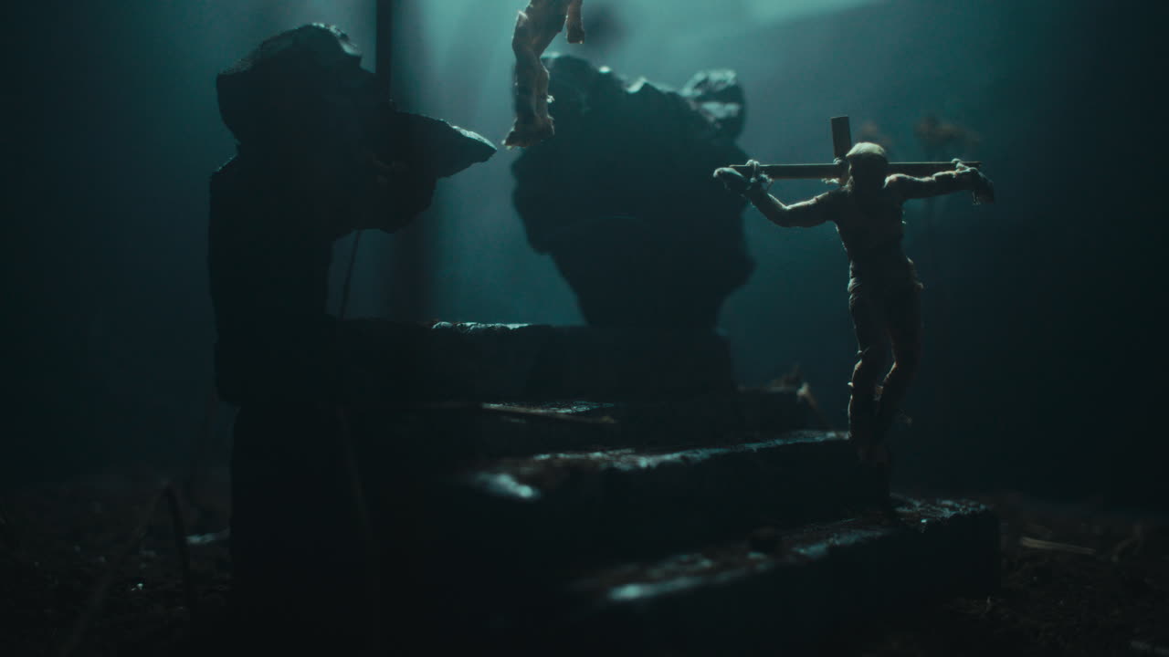 Miniature mummified dolls hanging on the gallows at night