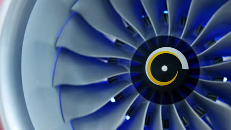 close-up of a jet engine turbine with blue light