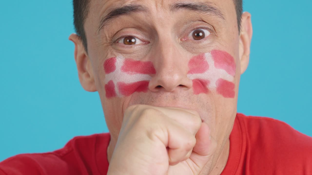 Very nervous man supporting danish team during a difficult match