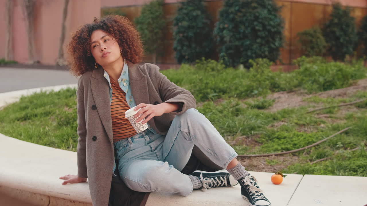 Young Woman Relaxing With Coffee Outdoors