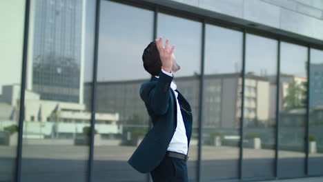 closeup man raising hands at street. businessman celebrating victory outdoor