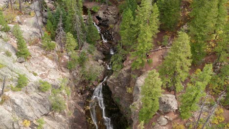 aerial drone footage moving down fish creek falls in steamboat springs, colorado