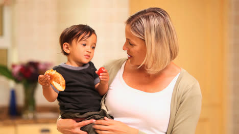 Mother-giving-baby-a-strawberry