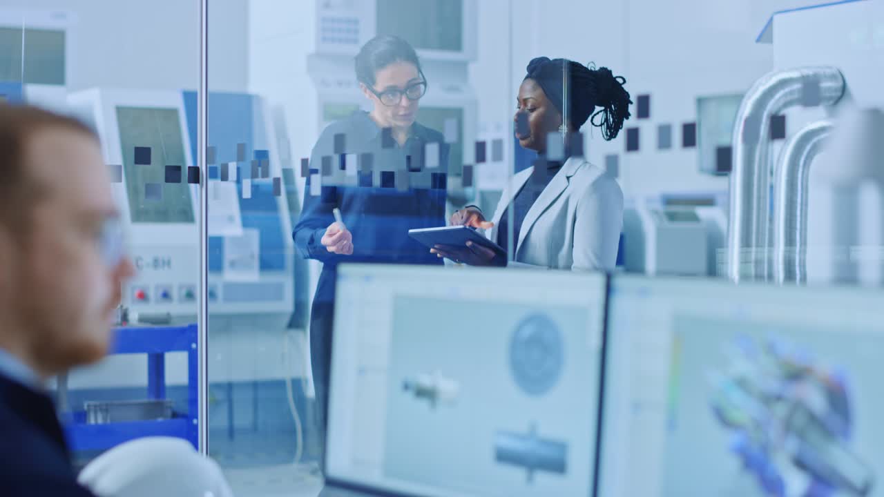 Industrial Engineer Talks with Project Supervisor, They Use Digital Tablet Computer and Discuss Modern Factory Planning. Manufacturing Facility with CNC Machinery and Robot Arm Assembly Line