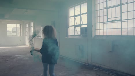 fashionable young woman in an abandoned warehouse