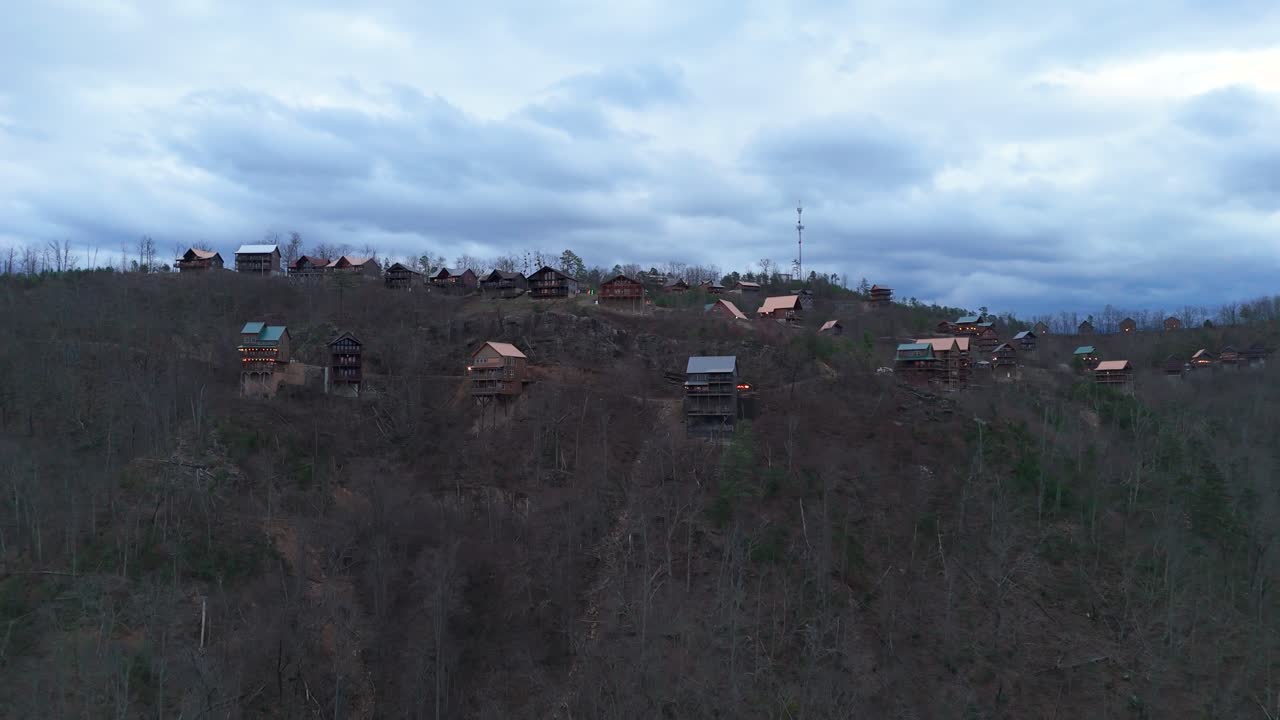 Aerial shot pulling out from cabins at the top of a mountain outside of Gatlinburg, TN.