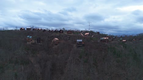 aerial shot pulling out from cabins at the top of a mountain outside of gatlinburg, tn.