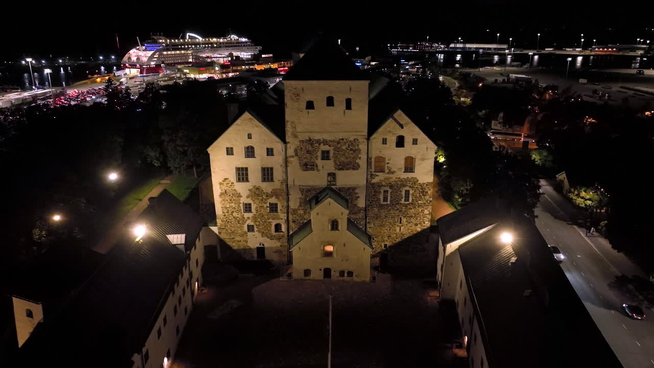 Night View of Historic Castle and Cruise Ship at Port