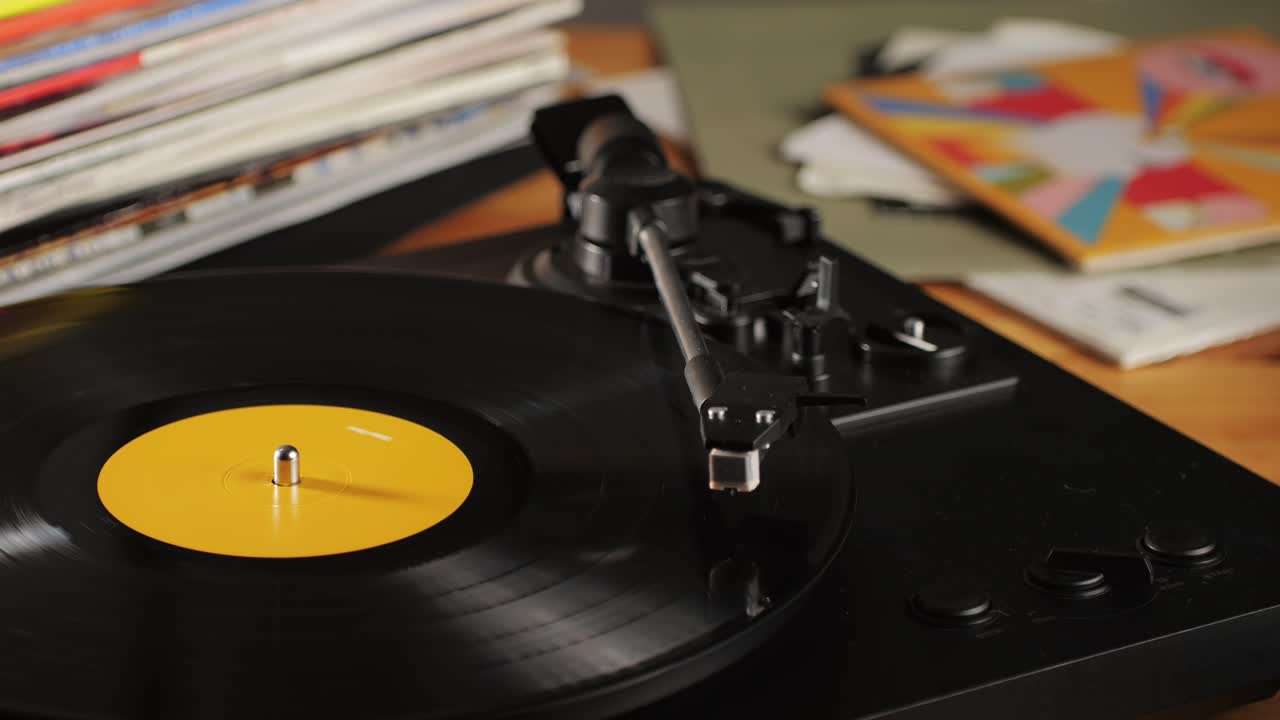 Retro Vinyl record player playing music, close-up macro shot of vintage LP disc old phonograph spinning. Retro music player.