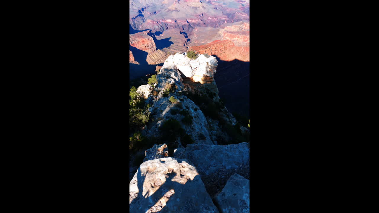 Fantastic scenery of the Grand Canyon National Park, Arizona, USA on sunny day. Drone footage over the rocks. Vertical video