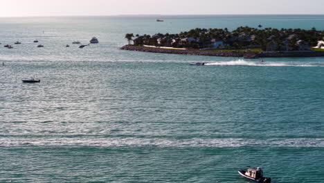 telephoto drone shot following a powerboat, golden hour in key west, florida, usa