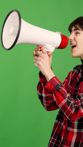 young person shouting and speaking into a megaphone on green screen