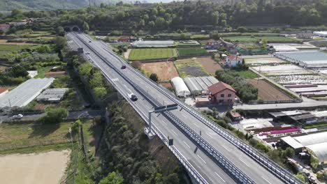 Drone-going-down-very-slowly,-see-a-beautiful-highway-on-Italian-Riviera,-Albenga