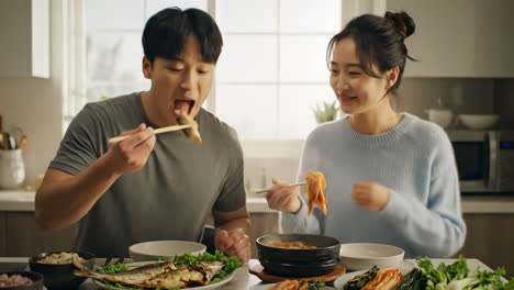 a couple enjoying a korean meal at home