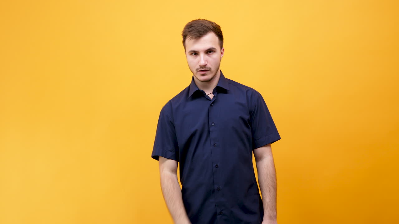 Man in blue shirt on yellow background
