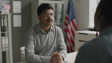 indian man attending visa interview in american embassy