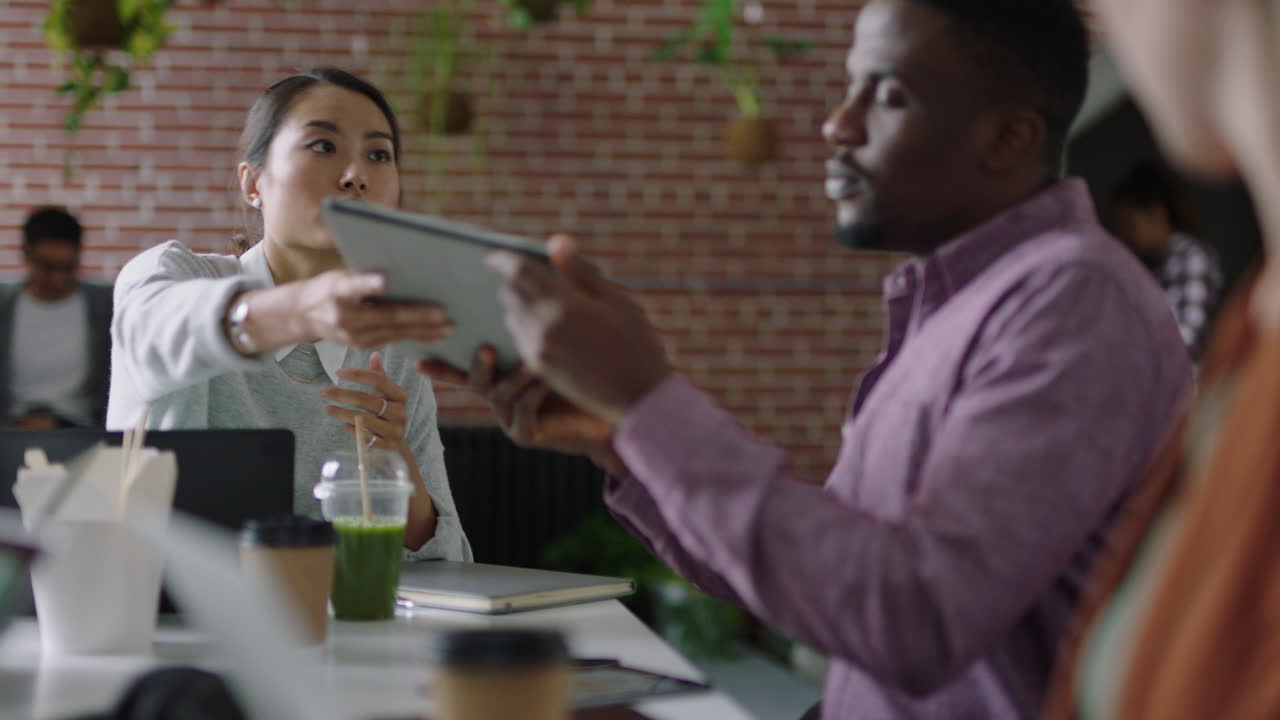 professional business people meeting african american businessman using tablet computer sharing financial research data showing marketing team graph statistics on screen in office presentation