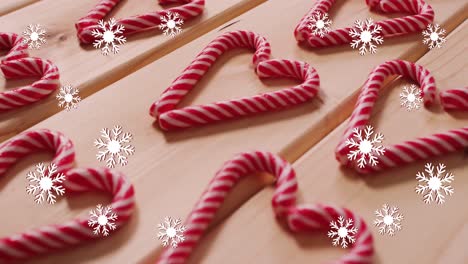 Animation-of-snow-falling-over-christmas-candy-canes