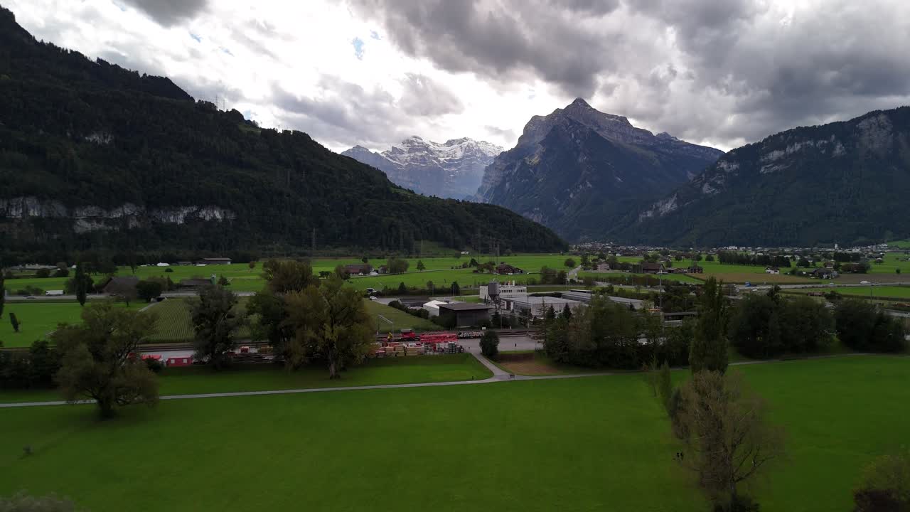 Alpine landscape aerial over field in Switzerland view of Swiss Alps mountains