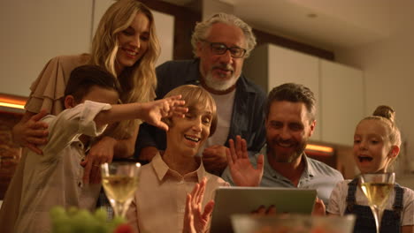 family waving hands at camera during video call. people video chatting online