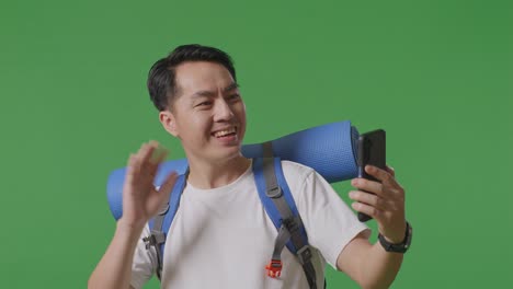 man taking selfie with backpack