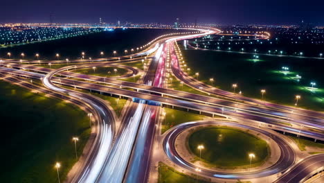 aerial night view of a highway interchange with light trails