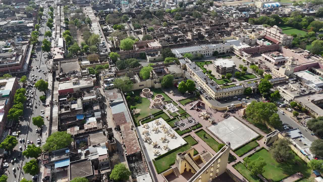Aerial drone shot of a historic fort wall stretching across the hills of Jaipur.