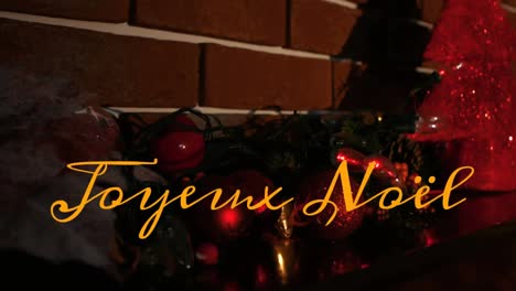 Animation-Von-Joyeux-Noel-Text-über-Weihnachtsdekorationen