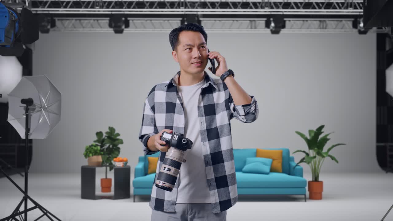 Photographer Talking on Phone in a Studio