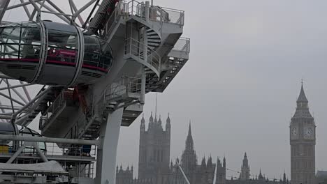 the london eye rotating next to big ben, united kingdom