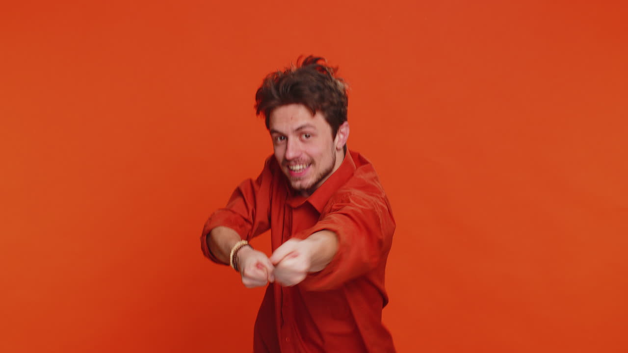 Mime caucasian man pulling an imaginary unreal invisible rope puts lot of effort success promotion