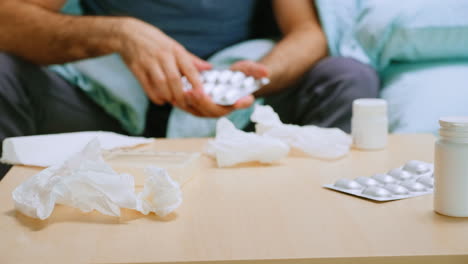 close up of sick man checking his pills