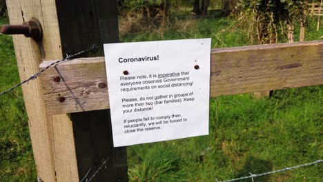 coronavirus warning sign in the english countryside
