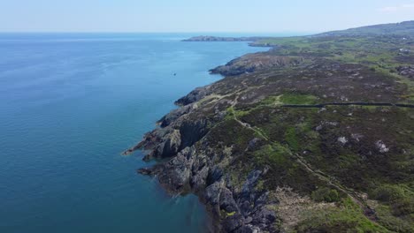 peaceful amlwch anglesey north wales rugged mountain coastal walk aerial rising tilt down shoreline view