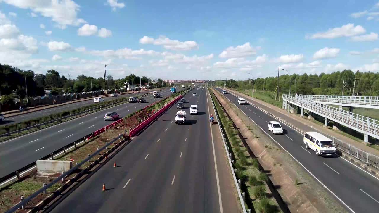 Heavy traffic on highway in Africa with rows of cars in busy city commute, overview from above overpass, static