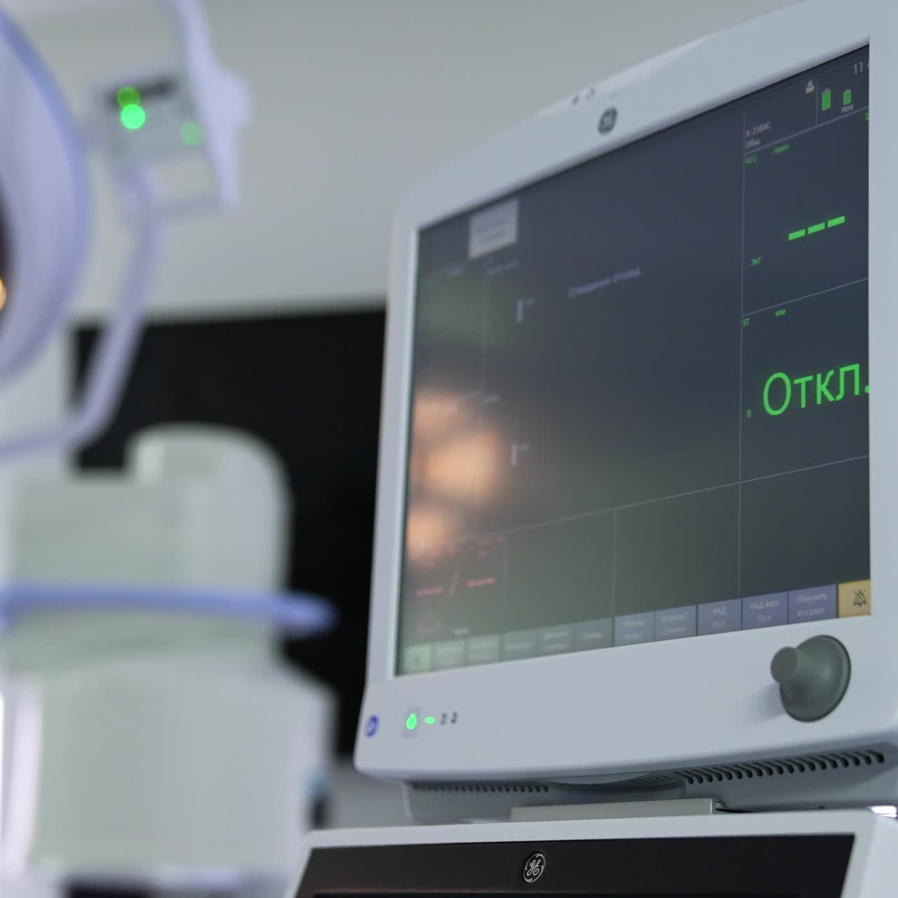 Doctor's hand pointing at the switched on monitor of lung ventilator. The machine isn't connected to a patient