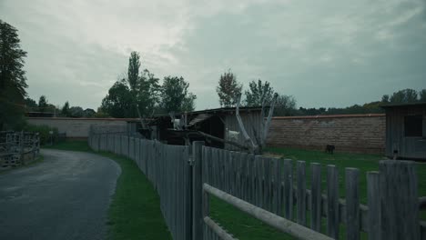 rustic wooden fenced enclosure with animal shelters and grazing space at schloss hof, austria