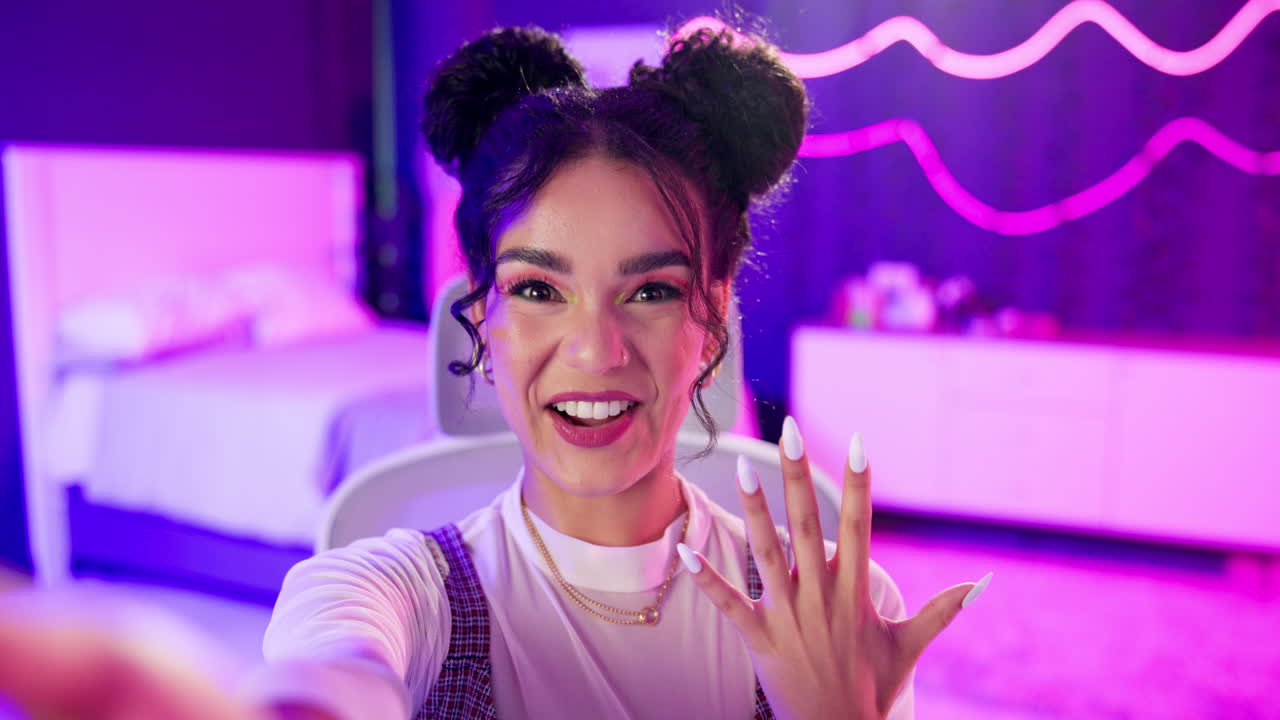 A smiling woman takes a selfie in her bedroom