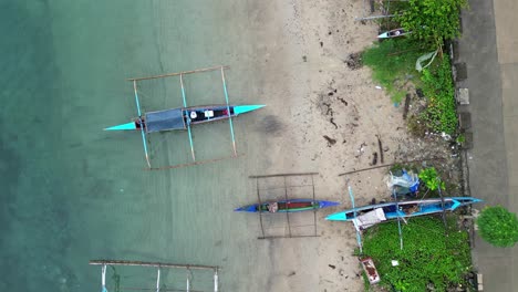 Aerial-top-view-of-outrigger-bangka-boats-in-Bato-town,-Catanduanes-island,-Philippines