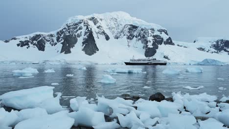 antarctica ship and beautiful scenery, cruise ship boat in dramatic amazing antarctic peninsula mountains scenery and winter landscape on tourist travel vacation and holiday to antarctica