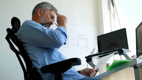 man checking document on desk 4k