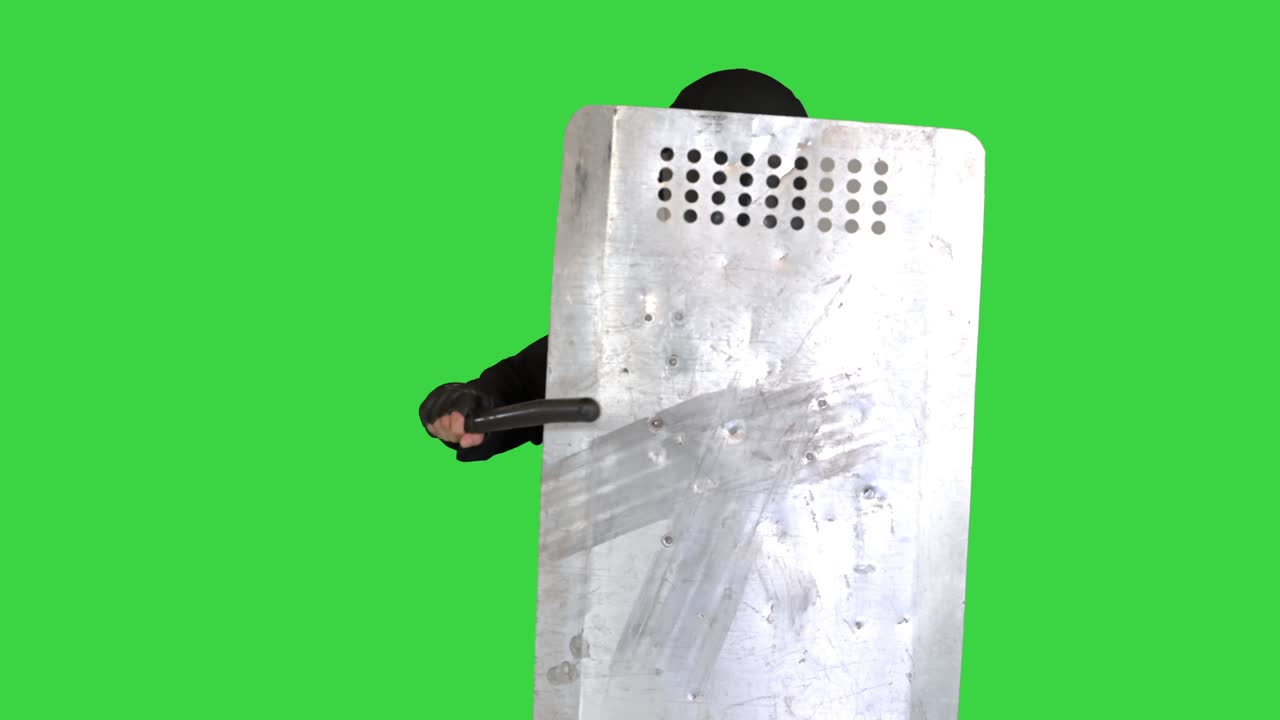 Riot police unit with the shield up and baton moving towards camera on a Green Screen, Chroma Key