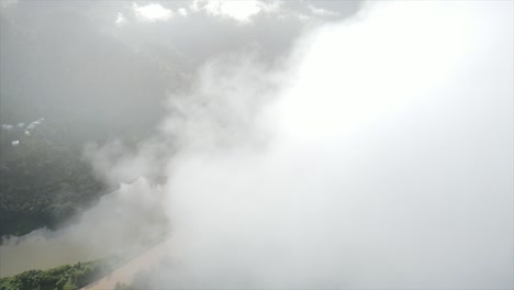 thick clouds over river in hilly forested valley