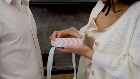 closeup of woman opening gift box