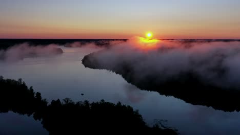 sunrise over river with morning fog