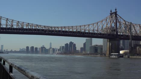 wide shot of queensboro bridge walkway with freedom tower in the distance