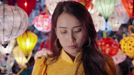 young woman strolling among colorful asian lanterns