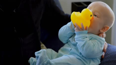 baby boy with his father playing with toy 4k