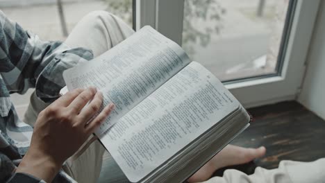 Catholic-faithful-person-reading-the-holy-bible-at